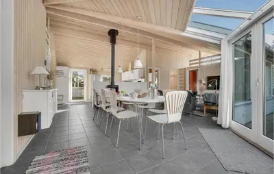 a kitchen and dining room with a table and chairs at 4 Bedroom Gorgeous Home In Fjerritslev in Fjerritslev