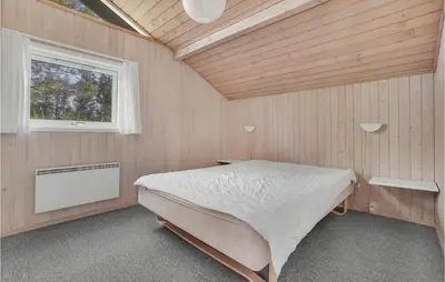 a bedroom with a bed in a room with a window at 4 Bedroom Gorgeous Home In Fjerritslev in Fjerritslev