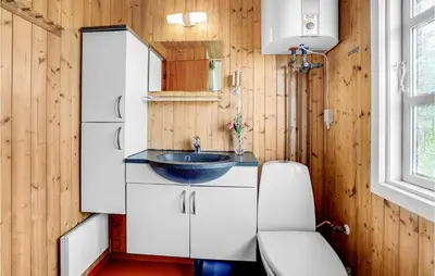 a small bathroom with a sink and a toilet at Holiday Home Svenstibakkevej Denmark Ii in Frøstrup