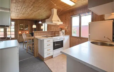 a kitchen with white cabinets and a stove top oven at Holiday Home Svenstibakkevej Frøstrup Iv in Frøstrup