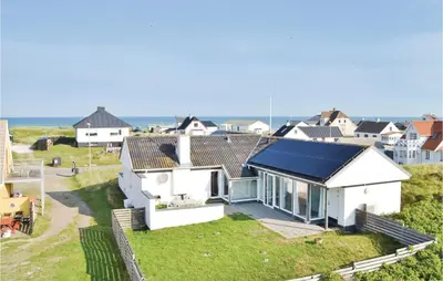 a white house with a blue roof at Gorgeous Home In Frøstrup With Wifi in Frøstrup