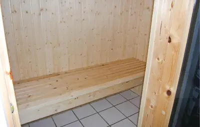 a wooden sauna with a wooden bench in a bathroom at Gorgeous Home In Frøstrup With Wifi in Frøstrup