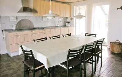 a kitchen with a large white table and chairs at Gorgeous Home In Frøstrup With Wifi in Frøstrup