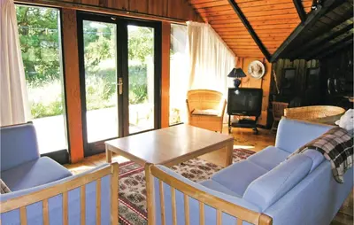 a living room with blue chairs and a table at Holiday Home C J Thaningsvej Fjerritslev X in Fjerritslev