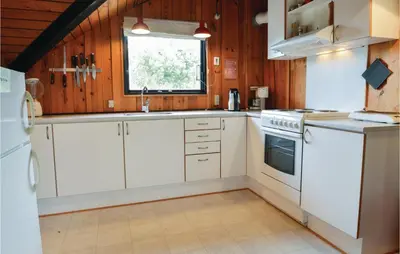 a kitchen with white cabinets and a window at Holiday Home C J Thaningsvej Fjerritslev X in Fjerritslev