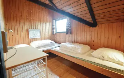 a room with two beds in a wooden wall at Holiday Home C J Thaningsvej Fjerritslev X in Fjerritslev