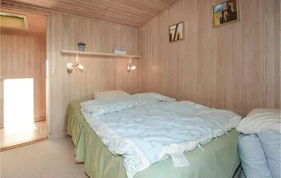 a bedroom with a large bed in a room at Jydehuset in Fjerritslev