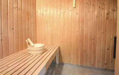 a interior of a sauna with a bucket and two bats at 4 Bedroom Stunning Home In Fjerritslev in Fjerritslev
