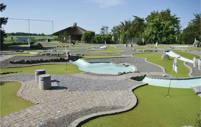 a golf course with a water park with slides at Holiday Home Gloryvej Harboøre Iv in Harboør