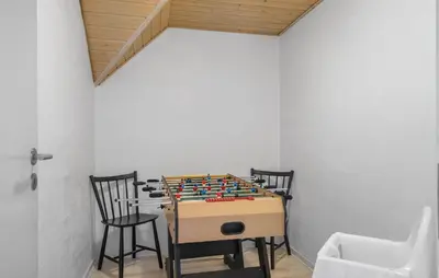 a chess table in a room with two chairs at Gorgeous Home In Harboøre With Sauna in Harboør