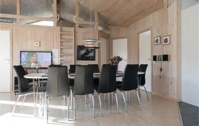 a dining room with a table and black chairs at Amazing Home In Saltum With Wifi in Saltum