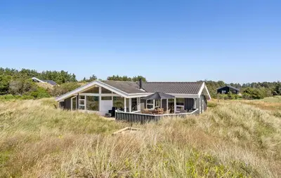 a house on a hill in a field at Holiday Home Monasvej Løkken Iv in Løkken