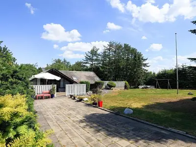 a yard with a house and a patio at 8 person holiday home in Løgstør-By Traum in Løgstør