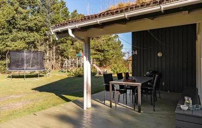 a pavilion with a table and chairs on a deck at 4 Bedroom Awesome Home In Saltum in Saltum