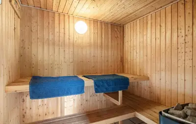 a sauna with a bench in a wooden room at 4 Bedroom Awesome Home In Saltum in Saltum