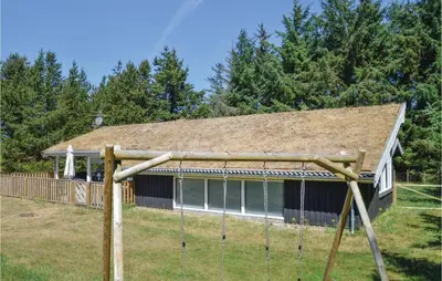 a house with a gambrel roof with swings at Stunning Home In Saltum With Sauna in Saltum