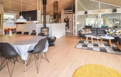 a kitchen and living room with a table and chairs at Stunning Home In Saltum With Sauna in Saltum