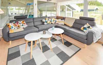 a living room with a couch and two tables at Stunning Home In Saltum With Sauna in Saltum