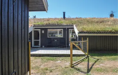 a house with a grass roof on top of it at Stunning Home In Saltum With Sauna in Saltum