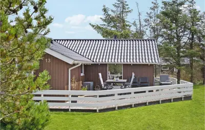 a house with a large deck and a patio at Holiday Home Kristavej Løkken Xii in Løkken