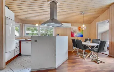 a kitchen and dining room with a table and chairs at Lovely Home In Saltum With Kitchen in Saltum