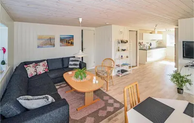 a living room with a couch and a table at Holiday Home Kristinesvej Blokhus X in Blokhus