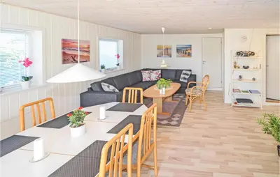 a living room with a couch and a table at Holiday Home Kristinesvej Blokhus X in Blokhus