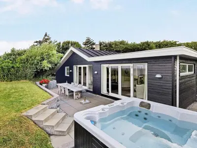 a small house with a hot tub in the yard at 6 person holiday home in Vinderup-By Traum in Vinderup