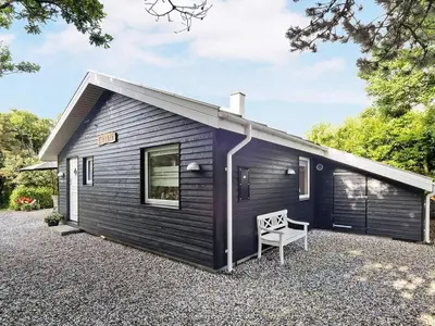 a black tiny house on a gravel lot at 6 person holiday home in Vinderup-By Traum in Vinderup