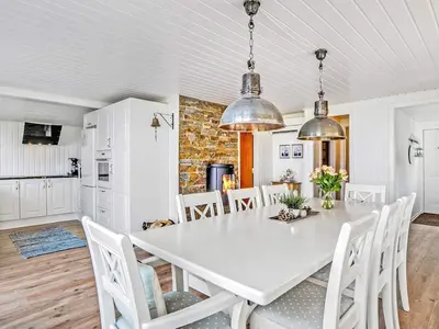 a kitchen and dining room with a white table and chairs at 6 person holiday home in Vinderup-By Traum in Vinderup