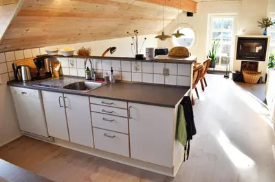 a kitchen with a sink and a counter top at Viking Surf Cottage in Klitmøller
