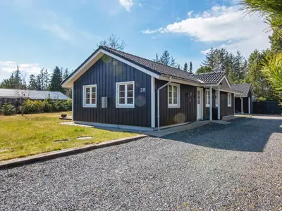 a small black house with a gravel driveway at 8 person holiday home in Løgstør-By Traum in Løgsted