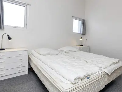 a white bedroom with a bed and a dresser at 4 person holiday home in Brovst-By Traum in Brovst