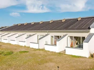 an exterior view of a white building with a black roof at 6 person holiday home in Brovst-By Traum in Brovst