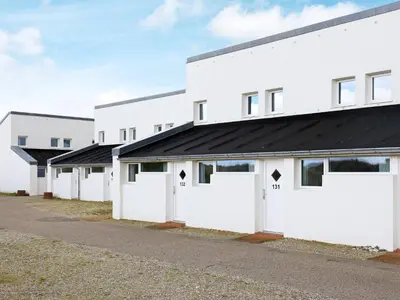 a row of white buildings with white doors at 6 person holiday home in Brovst-By Traum in Brovst