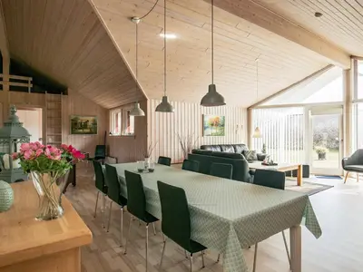 a dining room and living room with a table and chairs at 8 person holiday home in Brovst-By Traum in Brovst