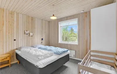 a bedroom with a bed and a window at Holiday Home Illeris Xi in Farsø