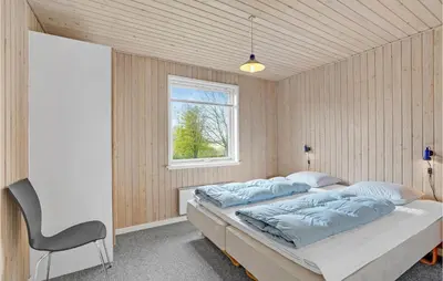 a bedroom with two beds and a window at Holiday Home Illeris Xi in Farsø