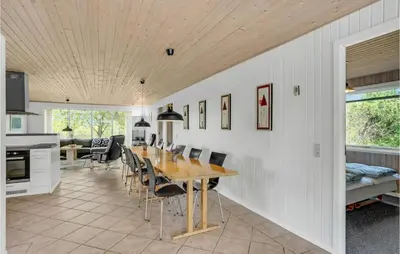 a kitchen and dining room with a table and chairs at Holiday Home Illeris Xi in Farsø
