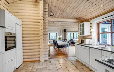 a kitchen with white cabinets and a dining room at Holiday Home Ramshule Farsø Xii in Farsø