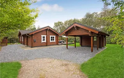 a log cabin with a pavilion in a yard at Holiday Home Ramshule Farsø Xii in Farsø