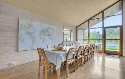 a long dining room with a table and chairs at Holiday Home Benediktesvej Løgstør X in Løgstør