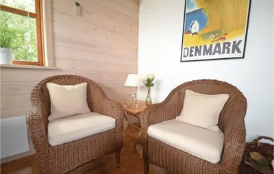 two wicker chairs and a table in a room at Holiday Home Benediktesvej Løgstør X in Løgstør
