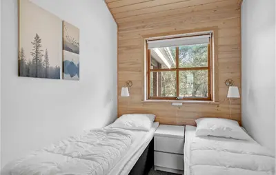 two beds in a small room with a window at Holiday Home Benediktesvej Løgstør X in Løgstør