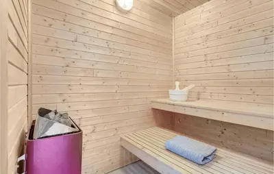 a sauna with a trash can and a bench at Holiday Home Benediktesvej Løgstør X in Løgstør