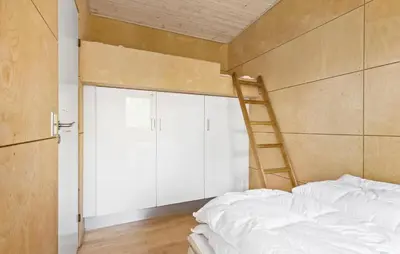 a bedroom with a bunk bed and a ladder at Amazing Home In Løgstør With Kitchen in Løgstør