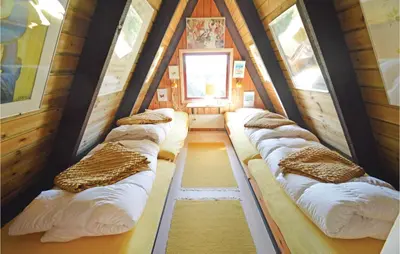 a group of beds in a room in a house at Holiday Home Golfsvinget in Farsø