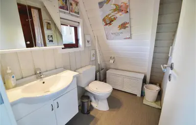 a small bathroom with a sink and a toilet at Holiday Home Golfsvinget in Farsø
