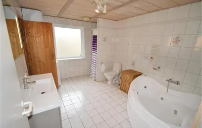 a white bathroom with a tub and a toilet at Holiday Home Illeris Farsø Ix in Farsø