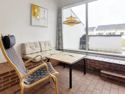 a living room with a chair and a table and a window at 6 person holiday home in Brovst-By Traum in Brovst